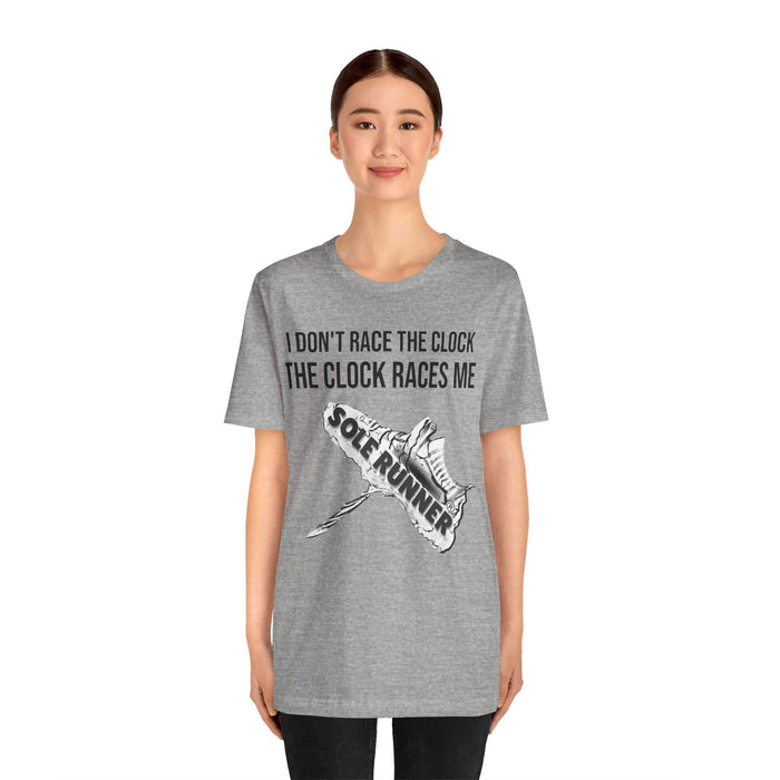 I Don't Race The Clock. The Clock Races Me: Unisex Jersey Short Sleeve Tee