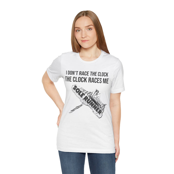 I Don't Race The Clock. The Clock Races Me: Unisex Jersey Short Sleeve Tee