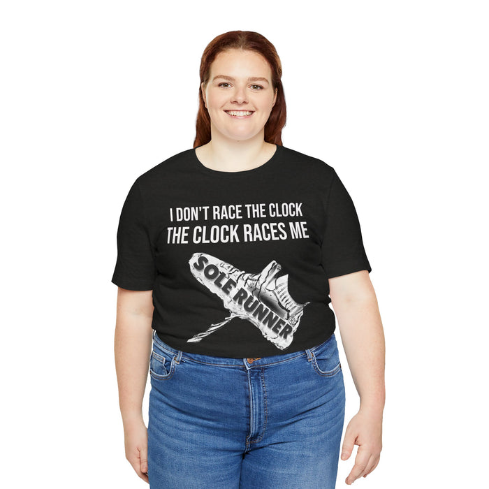I Don't Race The Clock. The Clock Races Me: Unisex Jersey Short Sleeve Tee
